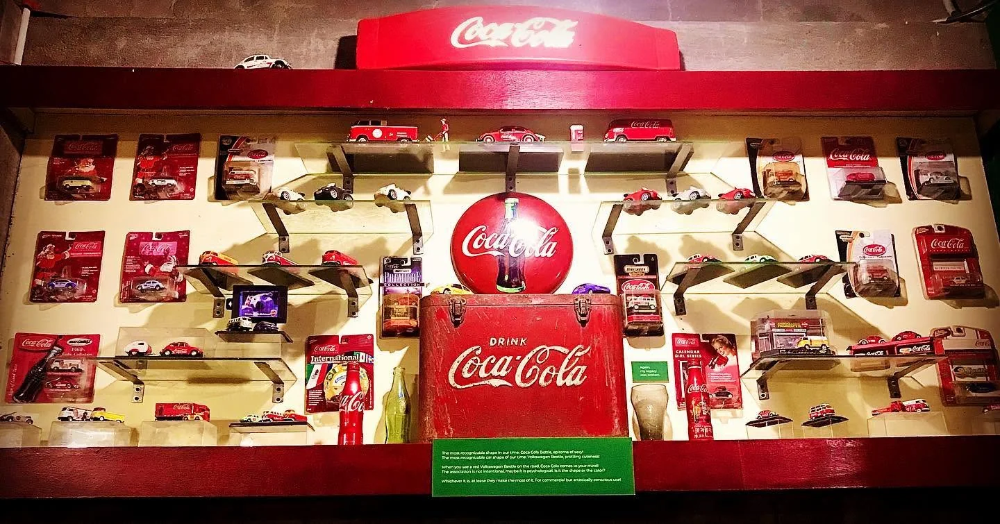 Diecast cars and Coca-Cola memorabilia display